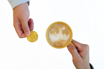 Conceptual trading a cup of coffee with gold bitcoin coin on white background