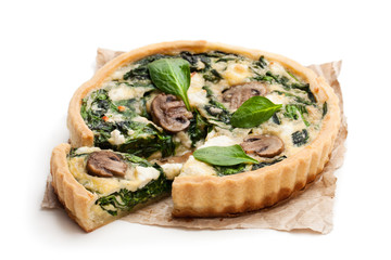 Traditional  french quiche pie with spinach and mushroom isolated on white