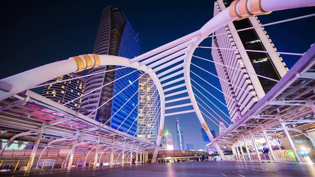 Time-lapse of People walking at Chong Nonsi skywalk at night, Bangkok, Thailand