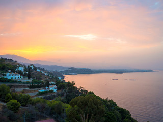 Sunrise over the Salobreña city coastline in Costa Tropical in Granada, Spain.