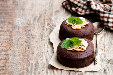 Chocolate  fondant with almonds on wooden table
