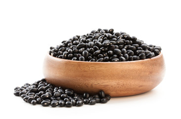 Raw  black beans in wooden bowl isolated on white - obrazy, fototapety, plakaty
