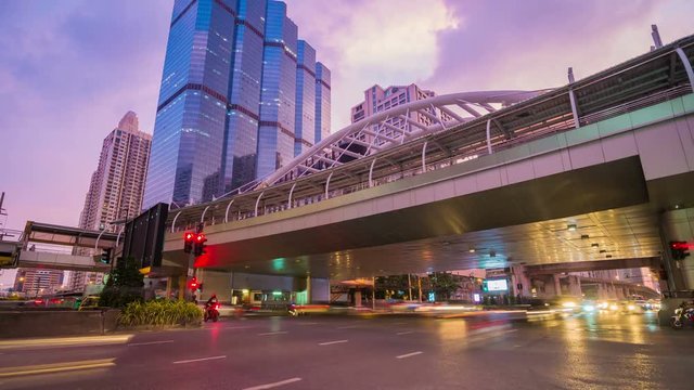 Time-lapse of public sky walk and traffic at Chong Nonsi sky train station at night, Bangkok, Thailand