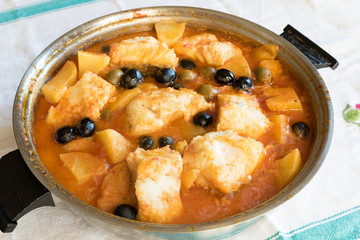 Salted cod stewed with olives