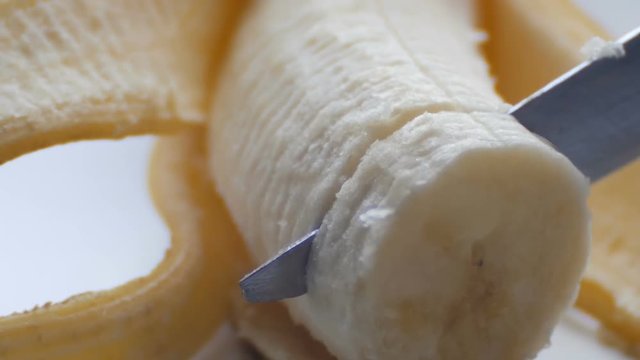 Woman sexually cut with a knife of purified banana, macro close up view