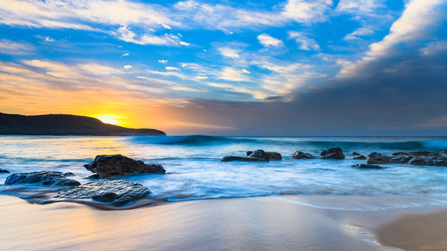 Blue Sunrise Seascape with Rocks and Clouds