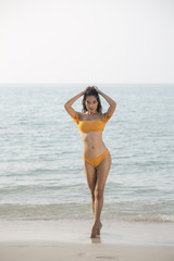 Beautiful asian woman posing at the the beach.
