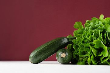 Rich green vegetables on modern exquisite marsala background.