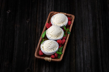 Fototapeta na wymiar Vanilla ice cream with bowl on wooden background