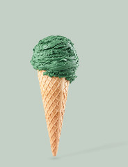 pistacchio ice cream with cone on gray background