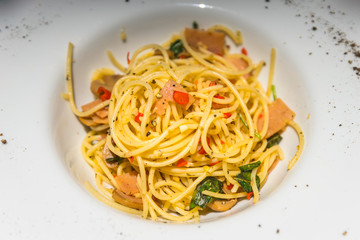 Home made style spaghetti on white ceramic plate