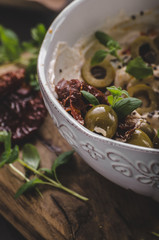 Fresh cheese with olives, dried tomatoes