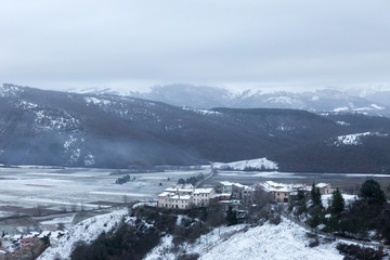 Fototapeta na wymiar View of Annifo town, near Colfiorito (Umbria), in the middle of winter snow. This little town was severely damaged by 1997 earthquake