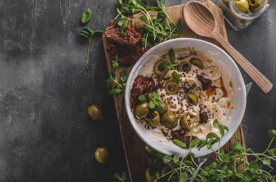 Fresh cheese with olives, dried tomatoes