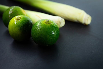 Lime and lemongrass in black background
