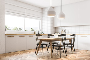 Corner of white kitchen and dining room