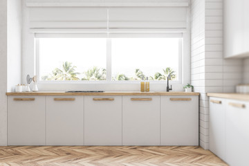 White kitchen countertops under window