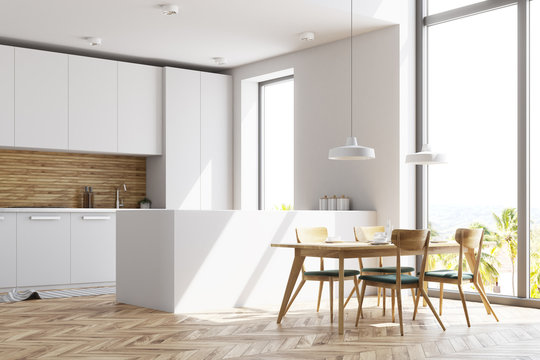 White and wooden kitchen with a table, side view
