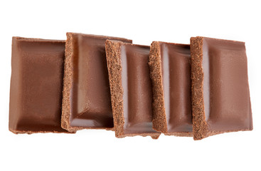 Milk chocolate pieces isolated on white background.