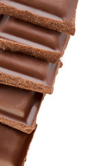 Milk chocolate pieces isolated on white background.