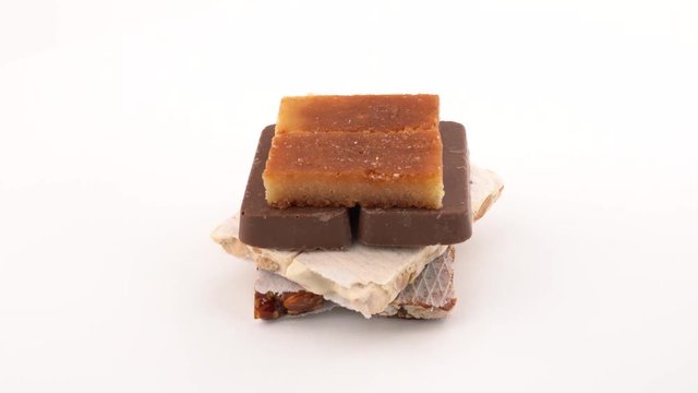 Soft and hard Turron traditional Christmas dessert in Spain and Italy and Latin America. Rotating on on white background. Isolated. Close up macro. Loopable.