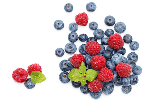 blueberry and raspberry berries isolated on white background