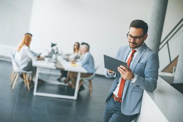 Young businessman with digital tablet in office