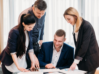 smiling business team looking at documents. successful company growth. positive financial results....