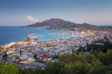 Obraz premium Aerial view of Zakynthos (Zante) town at sunset. Beautiful cityscape panorama of Greece city. Traveling concept background.