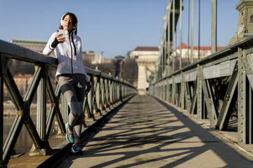 Woman on the bridge making a pause after the exercise