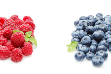 blueberry and raspberry berries isolated on white background