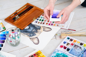 art painting inspiration creativity concept. artist creations. watercolors and drawings color swatches and brushes scattered on the floor