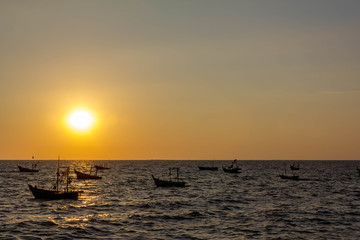 sunset on the ocean with traditional boat at bangsean thailand
