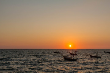 sunset on the ocean with traditional boat at bangsean thailand