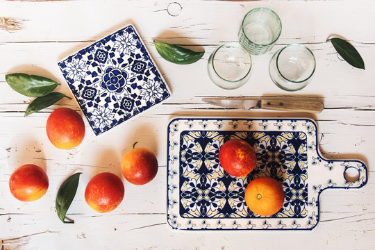 Preparing blood orange juice over white wooden table