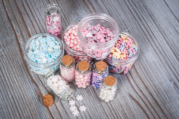 Various candy sprinkles in tiny storage cases