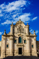 Fototapeta na wymiar Vertical View of the Church of San Francesco D'assisi on Blue Sky Background. Matera, South of Italy