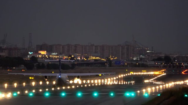 jet taking off at airport runway night view lights, aircraft rear view of flight landing