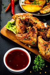 Roast chicken wings with baked potatoes