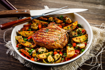 Grilled steak, baked potatoes and vegetables