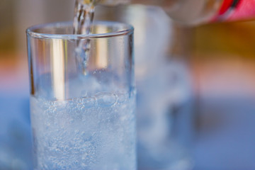 Pour water in glass, abstract food and drink background