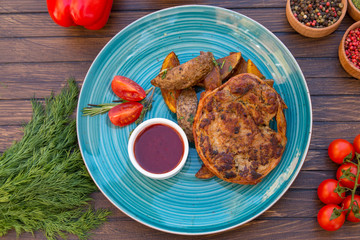 Grilled meat with baked potato and spicy sauce