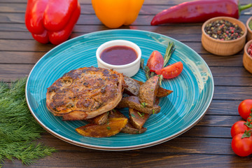 Grilled meat with baked potato and spicy sauce