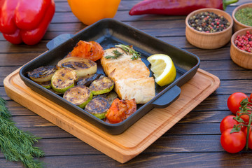Grilled  salmon with lemon on metal  slate background