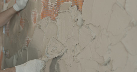 worker applying plaster on the wall