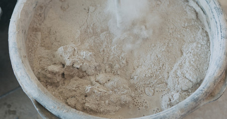 mixing concrete plaster with electric mixer
