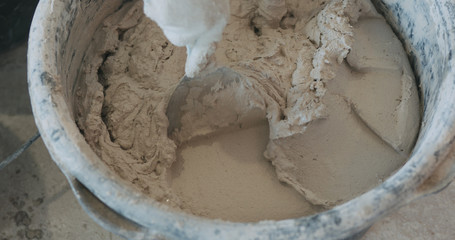 mixing concrete plaster with spatula