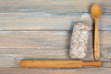 Many mixed breads and rolls of baked bread on wooden table background. Top view