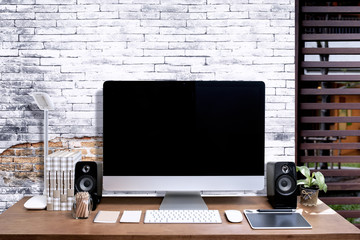 Stylish workspace with blank screen computer at home