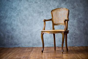 old chair on a gray wall background.